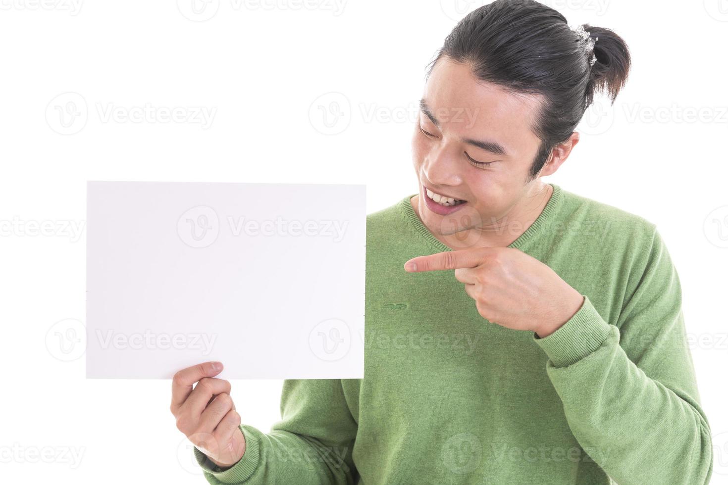 Handsome Asian man holding blank empty banner doing ok sign with fingers, smiling friendly photo