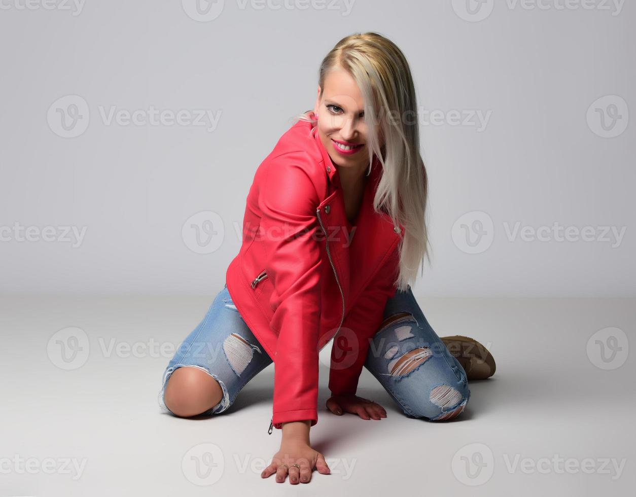 blonde trendy smiling woman wearing modern accessories posing in studio photo