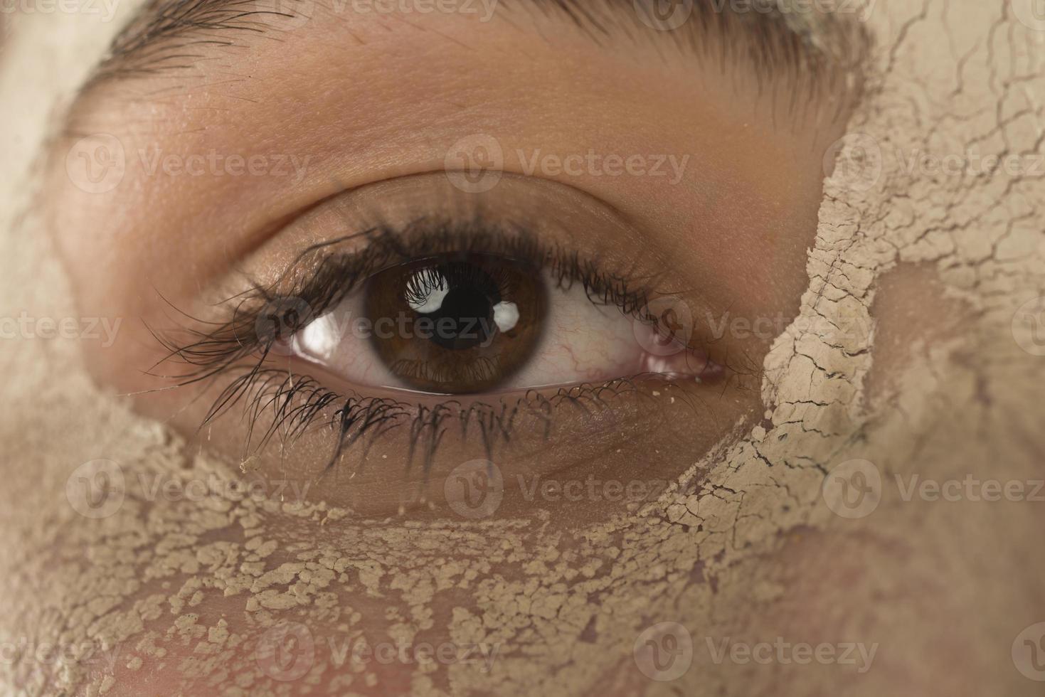 Beauty procedures skin care concept. Young woman applying facial mud clay mask to her face photo