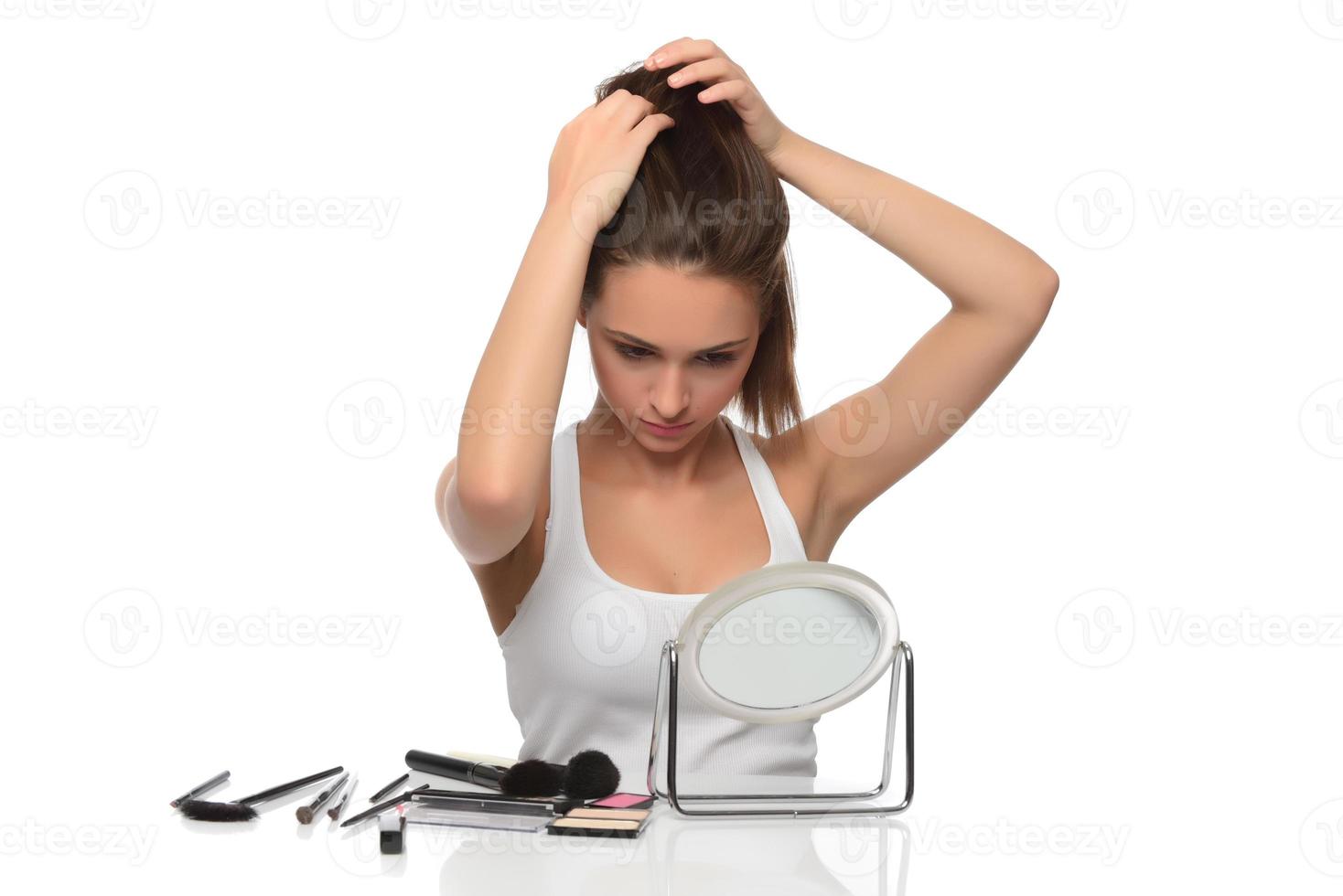 Young attractive smiling woman holding her strong hair photo