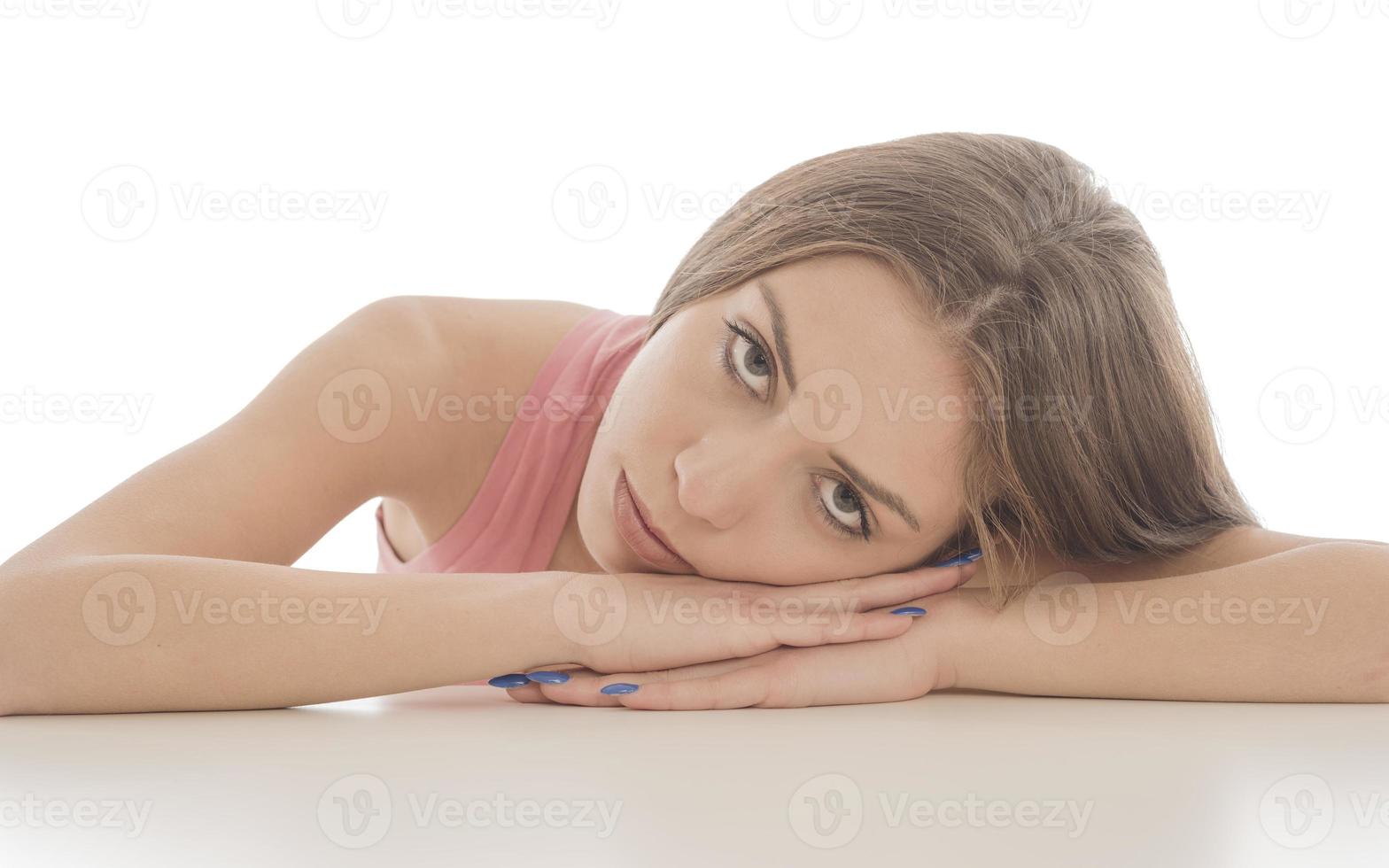 Beautiful woman sitting in front of a mirror. face of a healthy woman applying cream and makeup. Advertisement for skin cream, anti-wrinkle cream, baby face photo