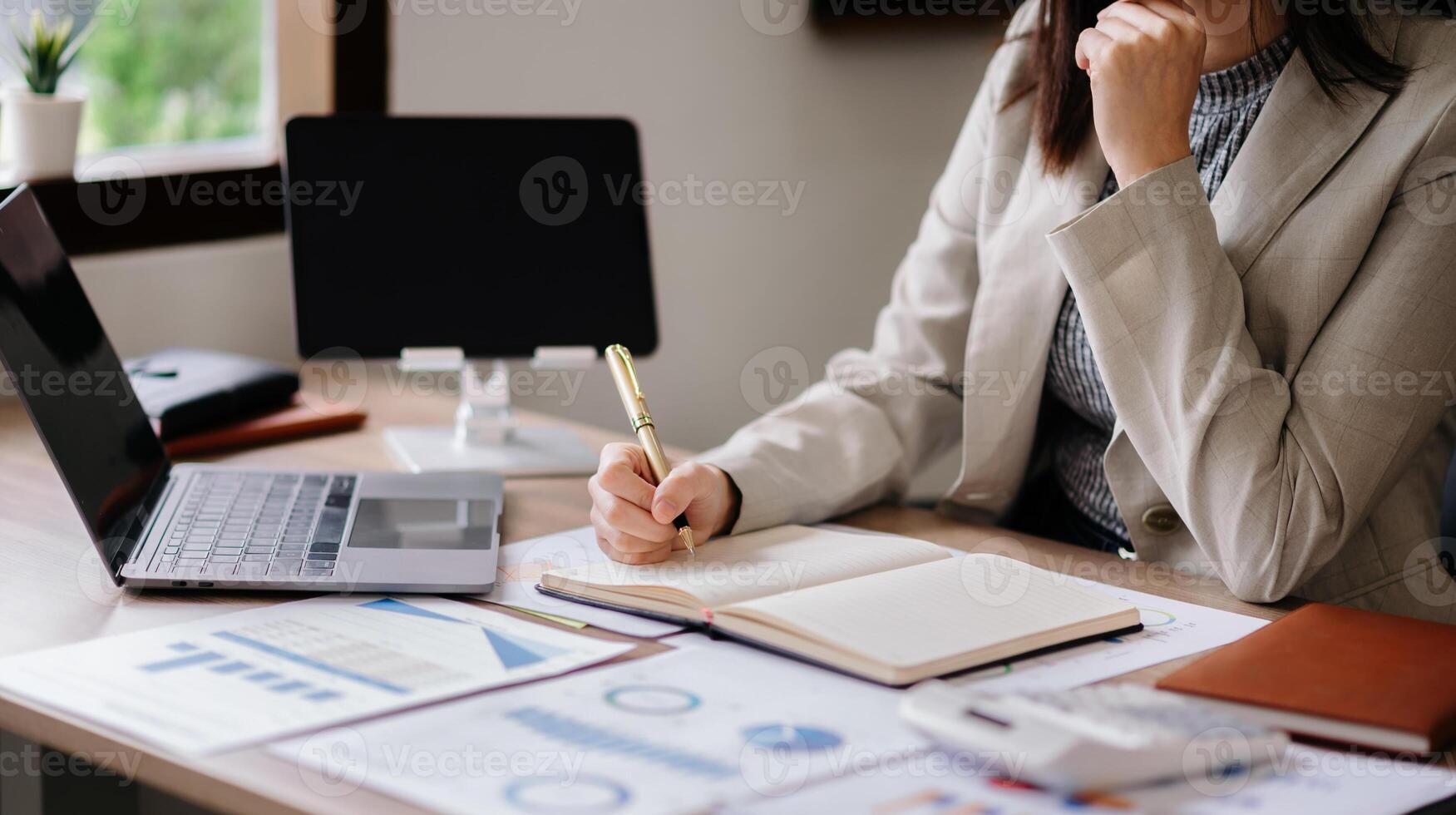 businessman hand working with new modern computer and writing on the notepad strategy diagram as concept morning light photo