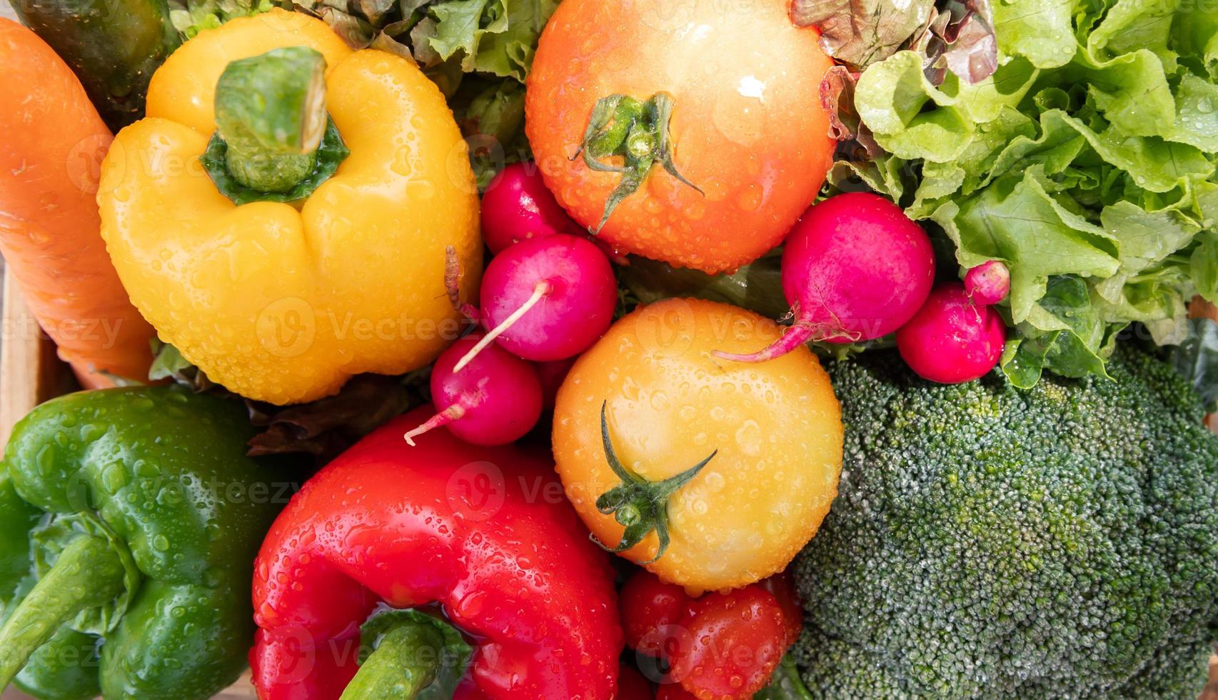 Wooden crate filled with fresh organic vegetables photo