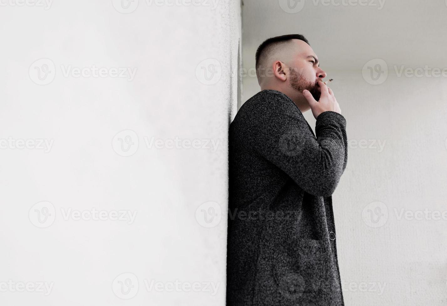 bearded hipster man smoking cigarette photo