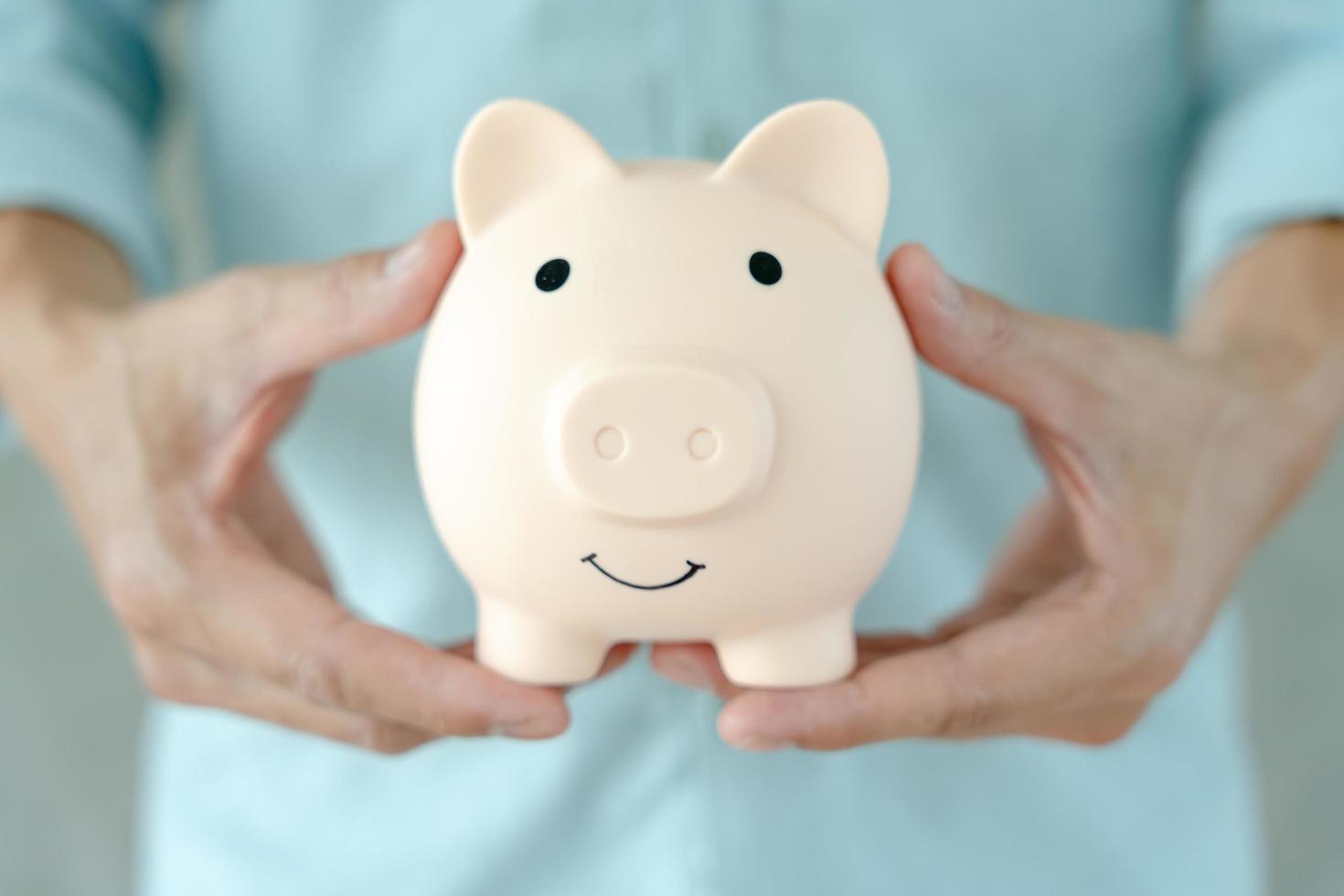 Save money. business woman putting coin into piggy bank for saving. wealth, Finance, business, investment, retirement, future, accounting, plan life, economize, banking, family, health. photo