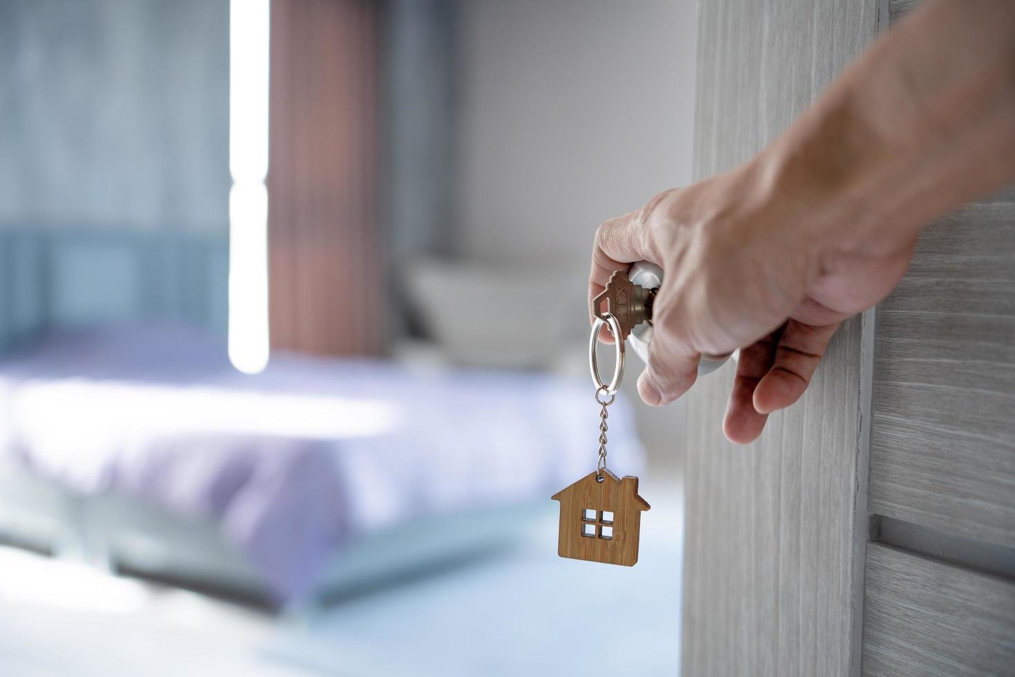 Landlord opened the door with the key inserted in the door. Selling home , New home, Mortgage, loan, rent, buy, sell, move in, move out, relocation photo