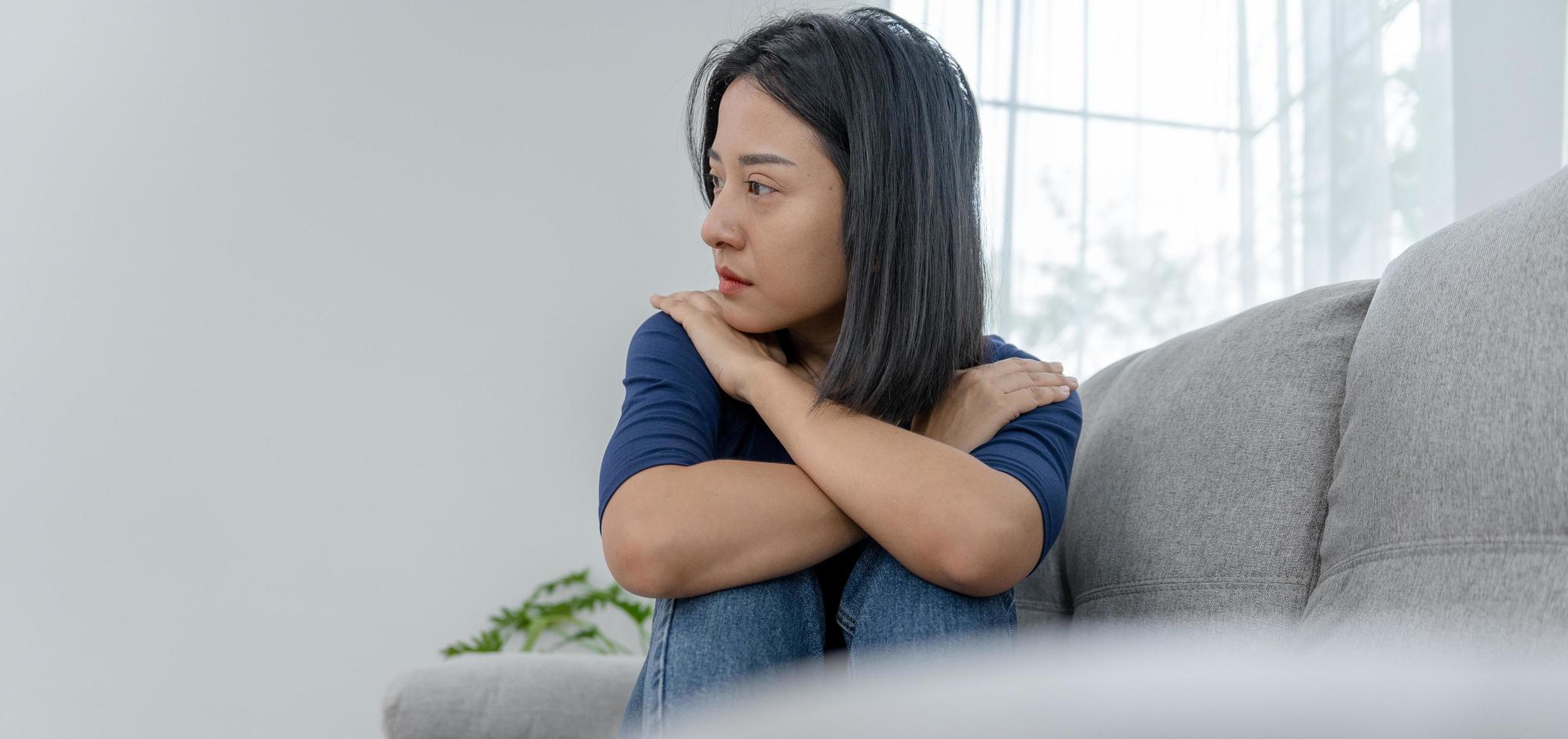 Depression and mental illness. Beautiful Asian woman disappointed and sad after receiving bad news. Stressed girl confused with unhappy problems in life, arguing with her boyfriend. photo