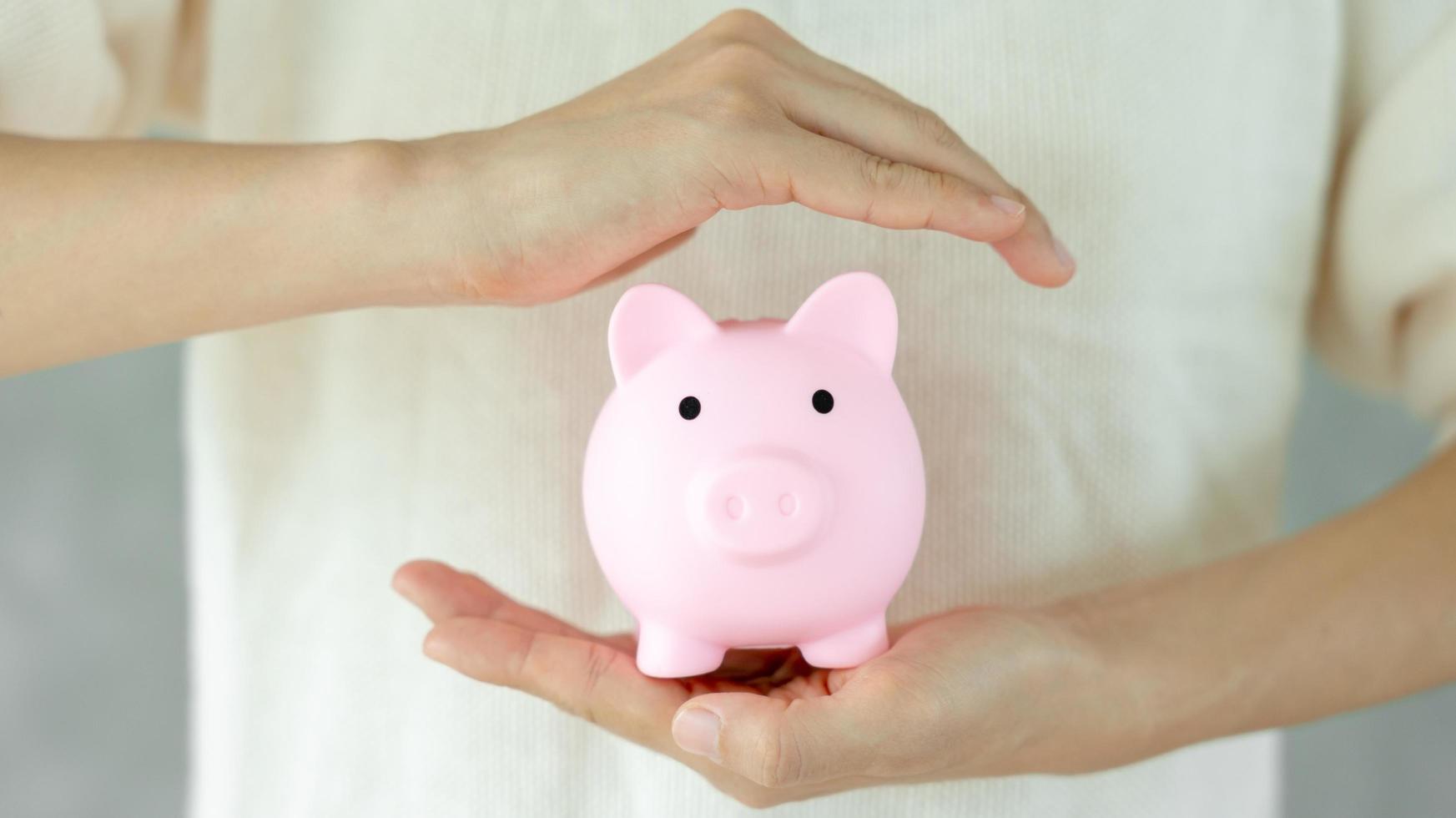 Save money. business woman putting coin into piggy bank for saving. wealth, Finance, business, investment, retirement, future, accounting, plan life, economize, banking, family, health. photo