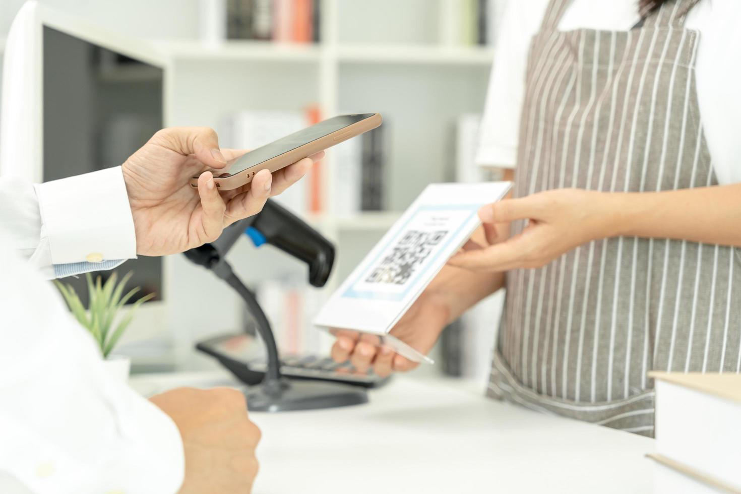 Closeup of a hand hold smartphone and scanning QR code payment. Accepted generate digital pay without money. E wallet and cashless technology.money online, Smart city, Digital transfer, cloud connect. photo