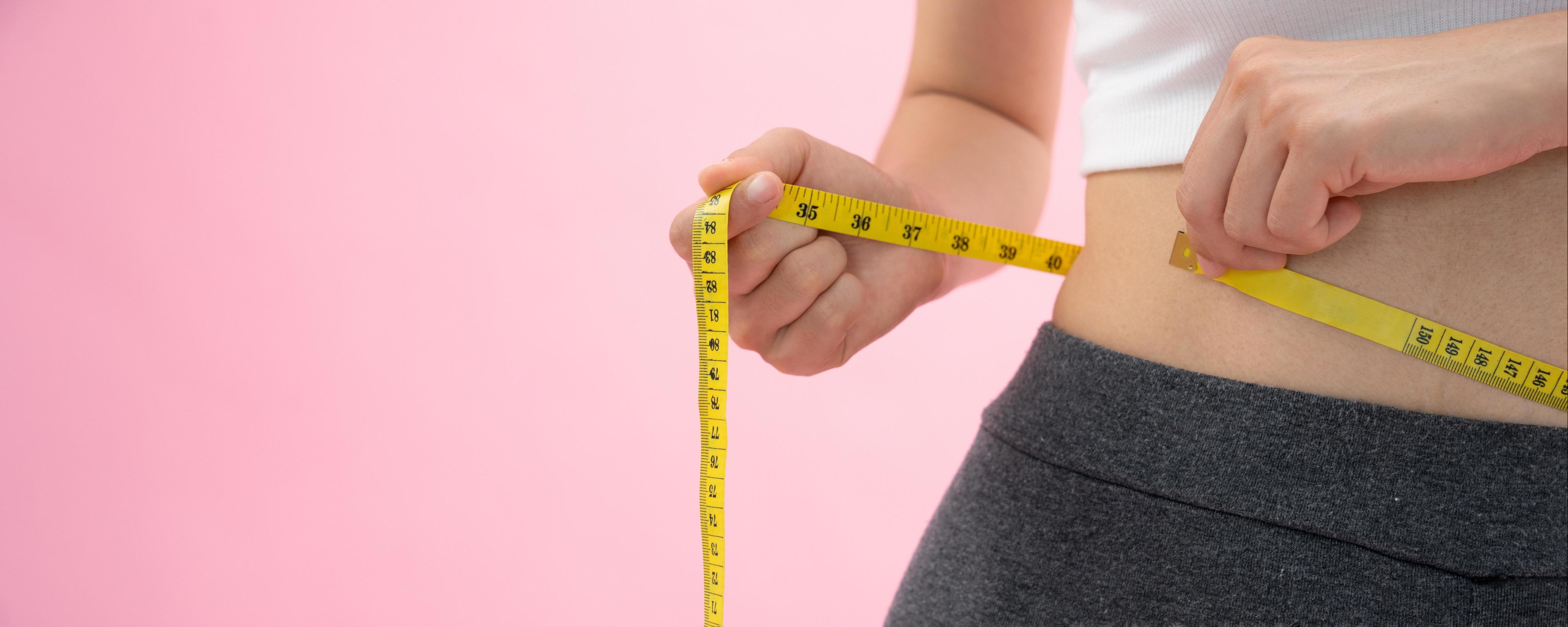 Diet and dieting. Beauty slim female body use tape measure. Woman in  exercise clothes achieves weight loss goal for healthy life, crazy about  thinness, thin waist, nutritionist. Fitness 25025259 Stock Photo at