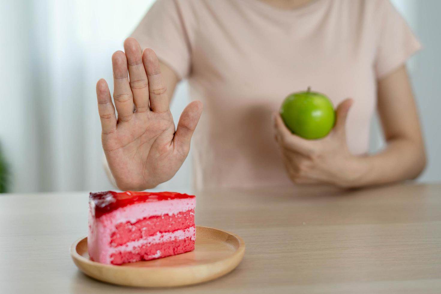 slim body Women choose during healthy foods and junk food, female choose green apple for diet. Good healthy food. weight lose, balance, control, reduce fat, low calories, routines, exercise. photo