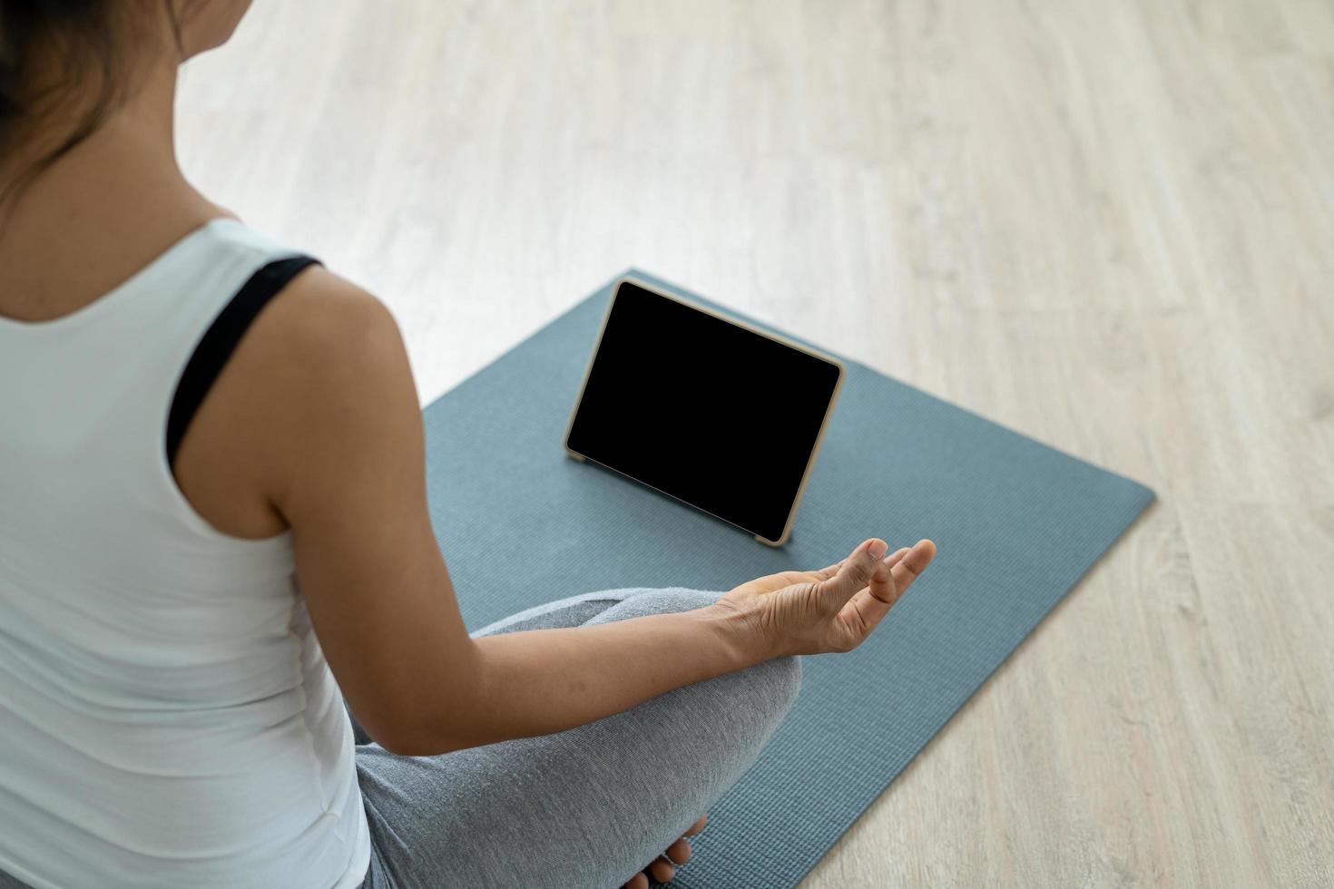 mujer practicando meditar en el parque. mujer asiática haciendo ejercicios por la mañana. equilibrio, recreación, relajación, calma, buena salud, feliz, relajarse, estilo de vida saludable, reducir el estrés, pacífico, actitud foto