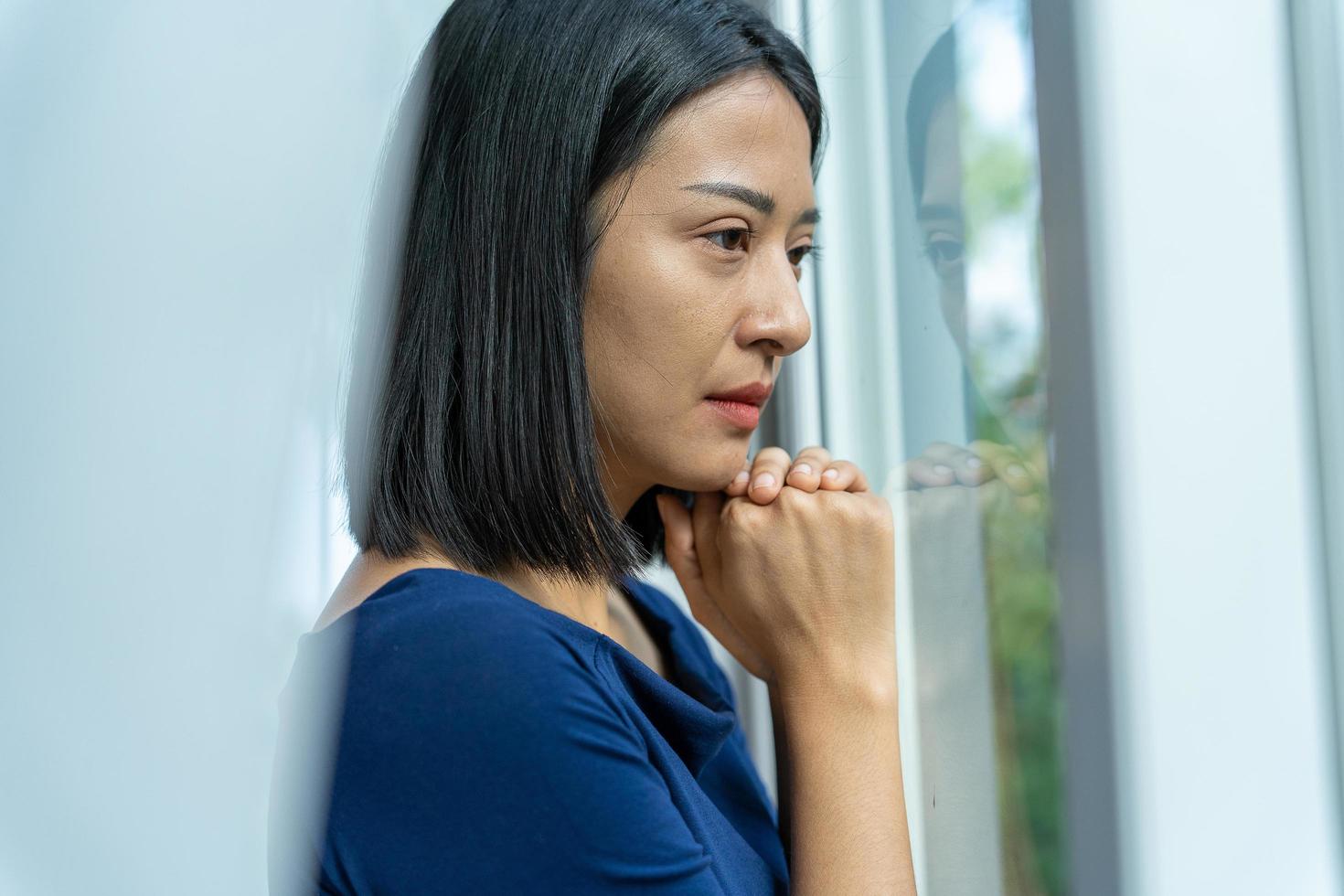 Depression and mental illness. Asian woman disappointed and sad after receiving bad news. Stressed girl confused with unhappy problems in life, arguing with her boyfriend. photo