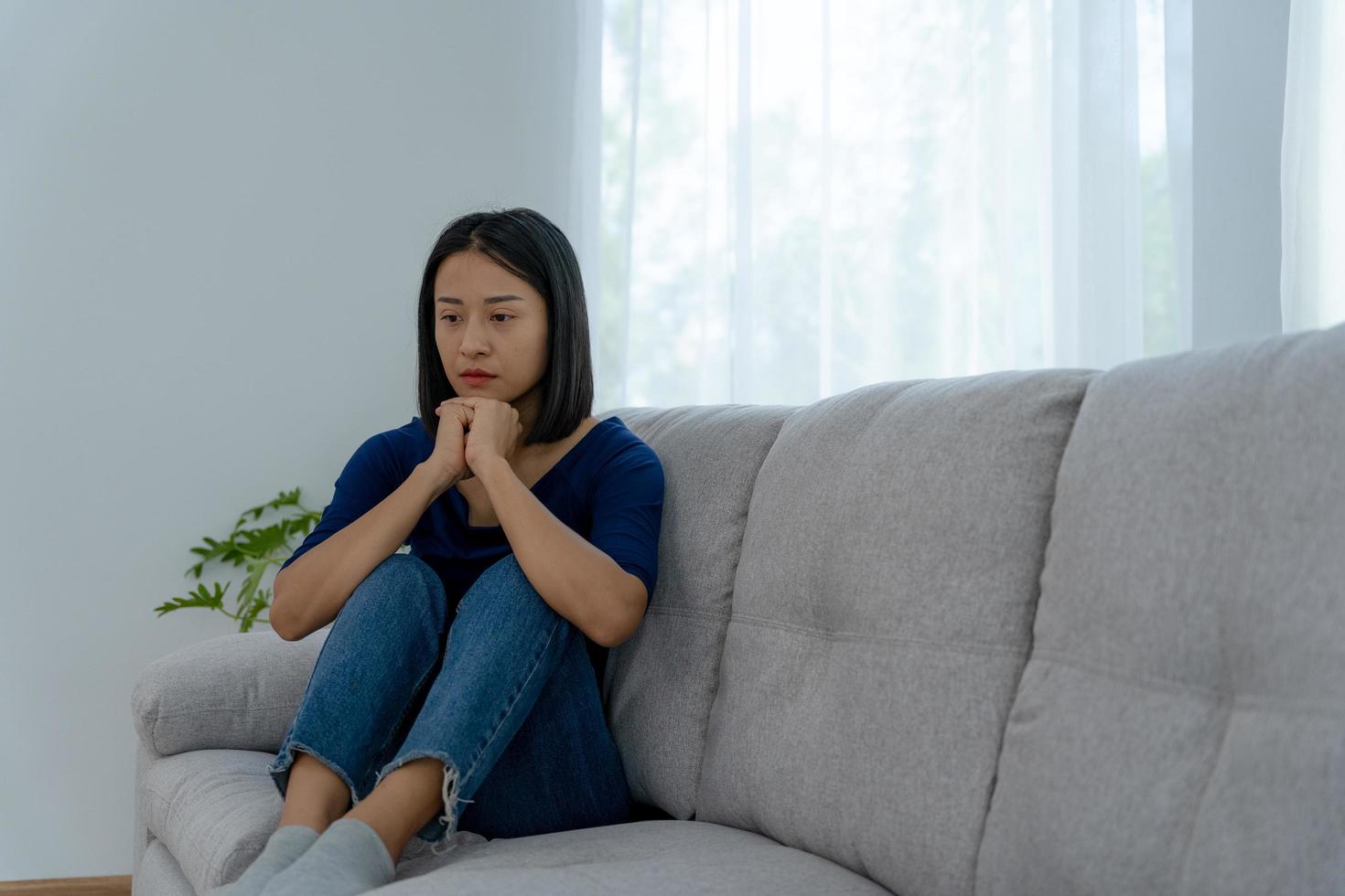 Depression and mental illness. Beautiful Asian woman disappointed and sad after receiving bad news. Stressed girl confused with unhappy problems in life, arguing with her boyfriend. photo