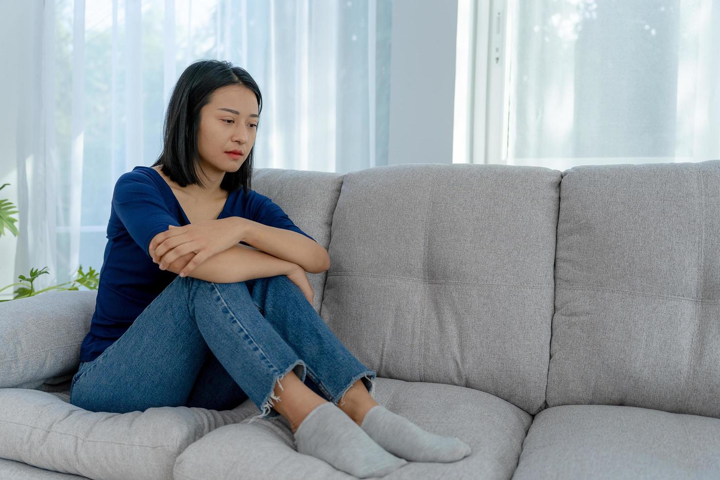 Depression and mental illness. Beautiful Asian woman disappointed and sad after receiving bad news. Stressed girl confused with unhappy problems in life, arguing with her boyfriend. photo