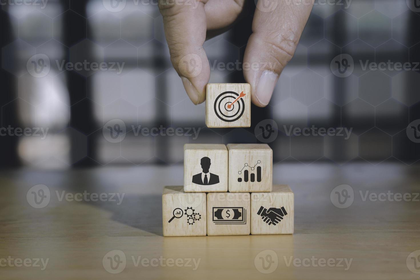 Concept of business strategy or e-commerce with shopping icons on wooden cubes against blue background. Business achievement goal and growth success objective concept. photo