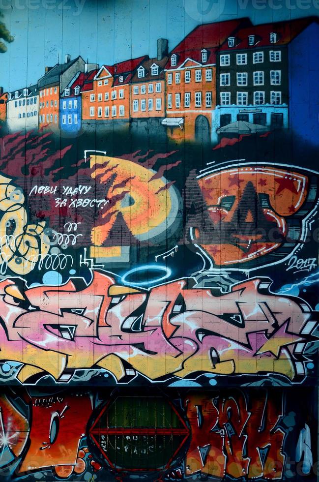 A fragment of detailed graffiti of a drawing made with aerosol paints on a wall of concrete tiles. Background image of street art with the architecture of Venice photo