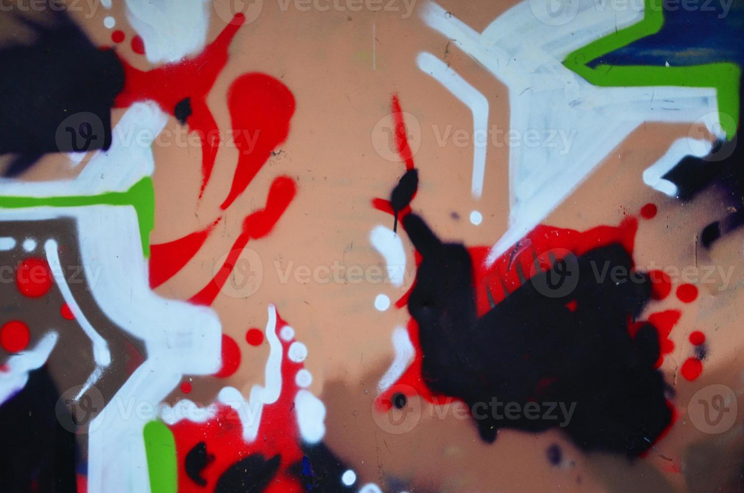 Background image with graffiti elements. Texture of the wall, painted in different colors of in the graffiti style. Concept of street culture, youth entertainment and illegal hooliganism photo