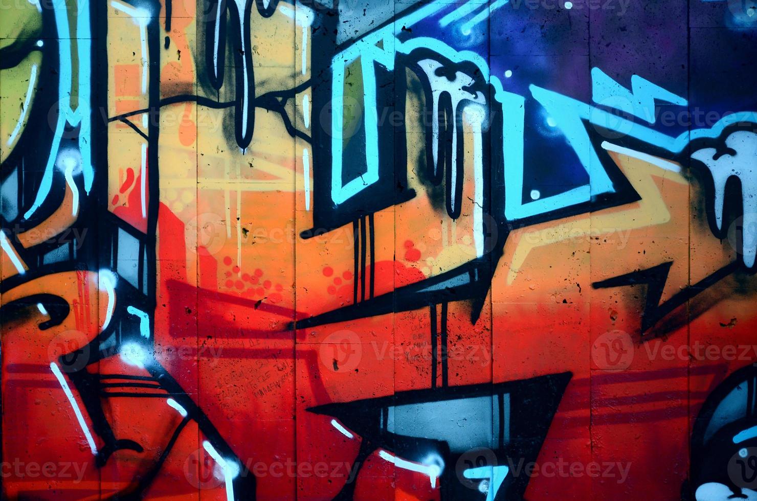 A fragment of detailed graffiti of a drawing made with aerosol paints on a wall of concrete tiles. Background image of street art in warm red color tones photo
