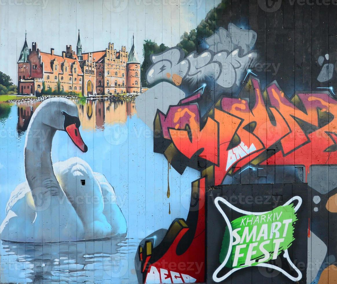 A fragment of detailed graffiti of a drawing made with aerosol paints on a wall of concrete tiles. Background image of street art with a huge white swan photo