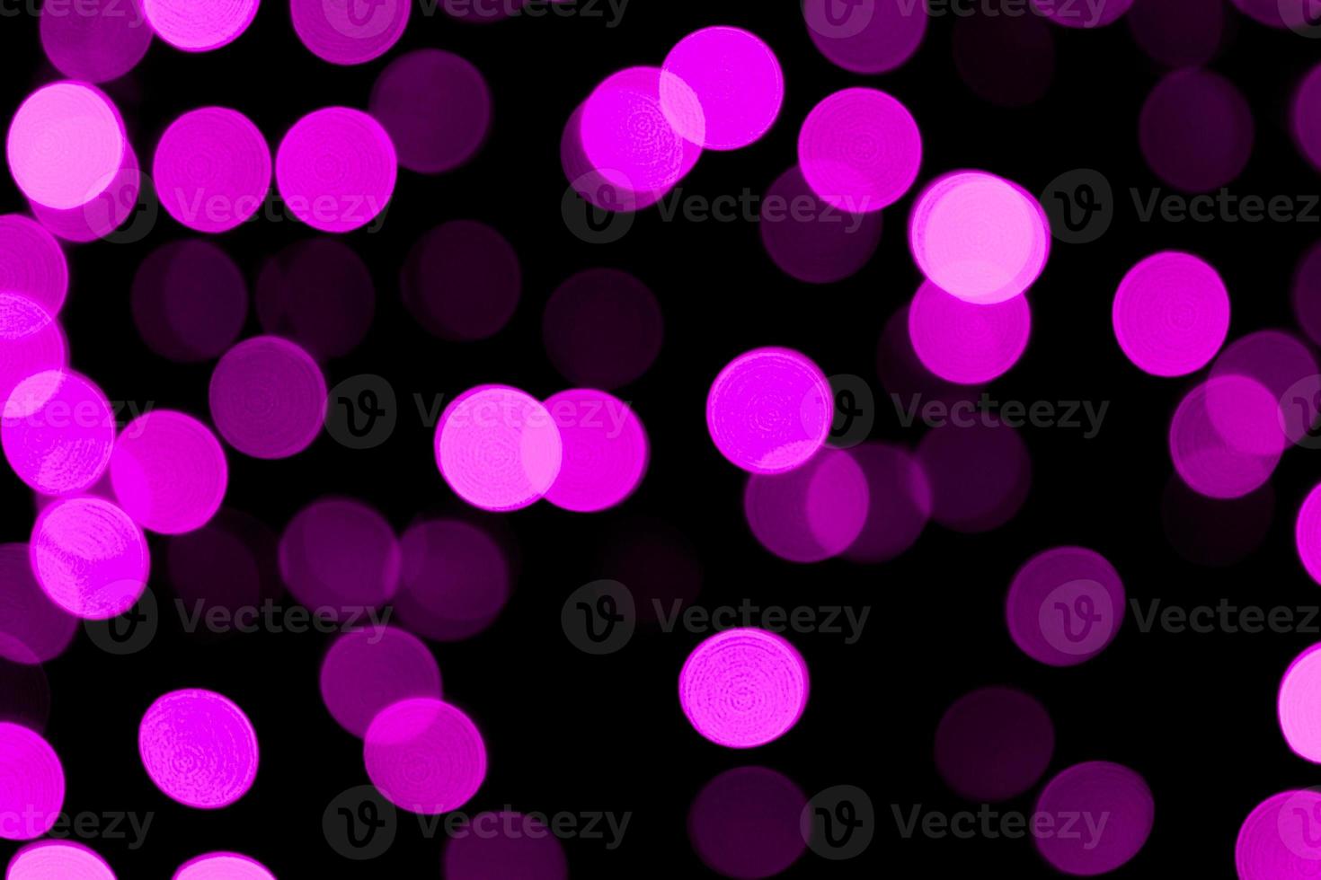 Unfocused abstract colourful bokeh purple background. defocused and blurred many round purple light photo