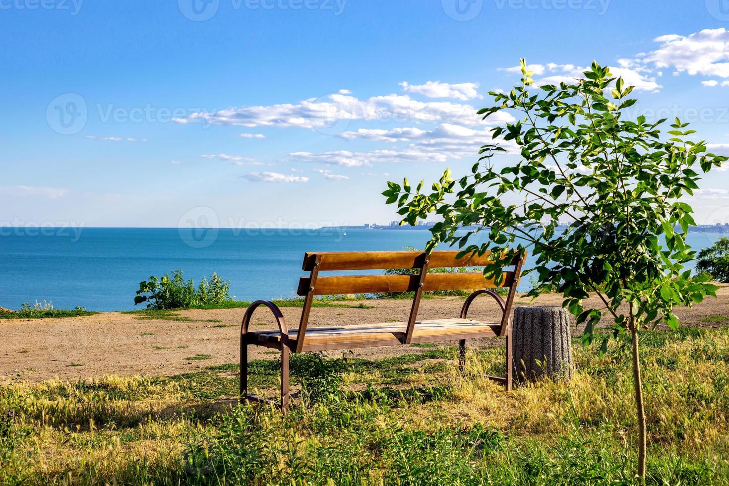 old wooden bench to rest on access to the beach, sunset at a beach of Baltic sea on summer evening photo