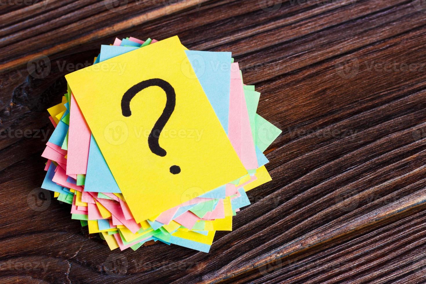 Concept for confusion, question or solution. question mark on wooden background photo