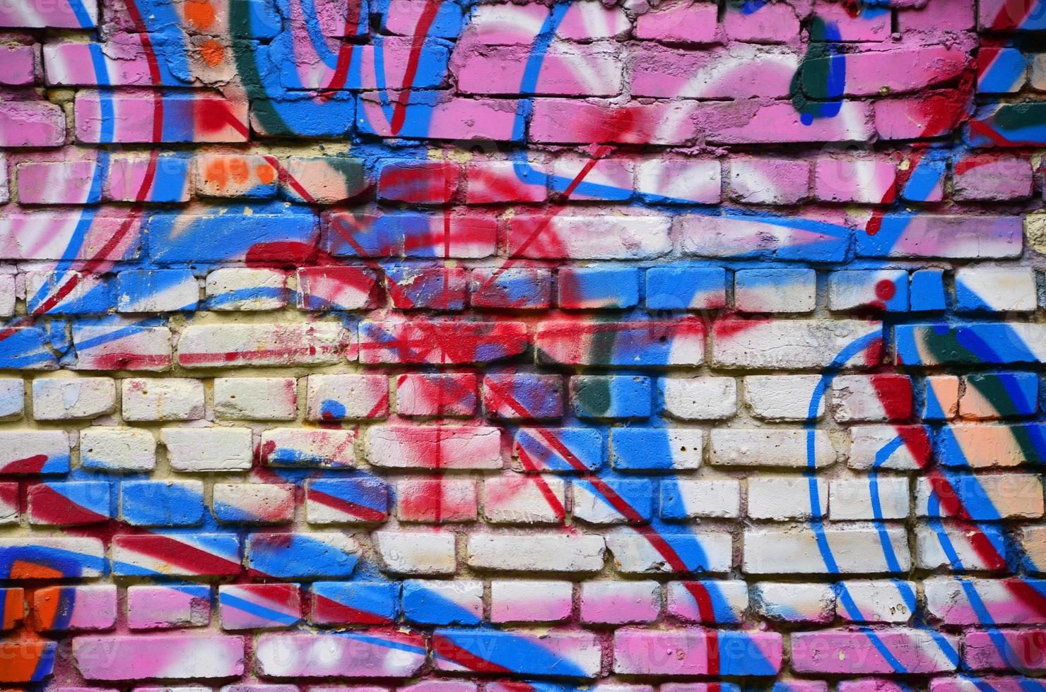 Background image with graffiti elements. Texture of the wall, painted in different colors of in the graffiti style. Concept of street culture, youth entertainment and illegal hooliganism photo