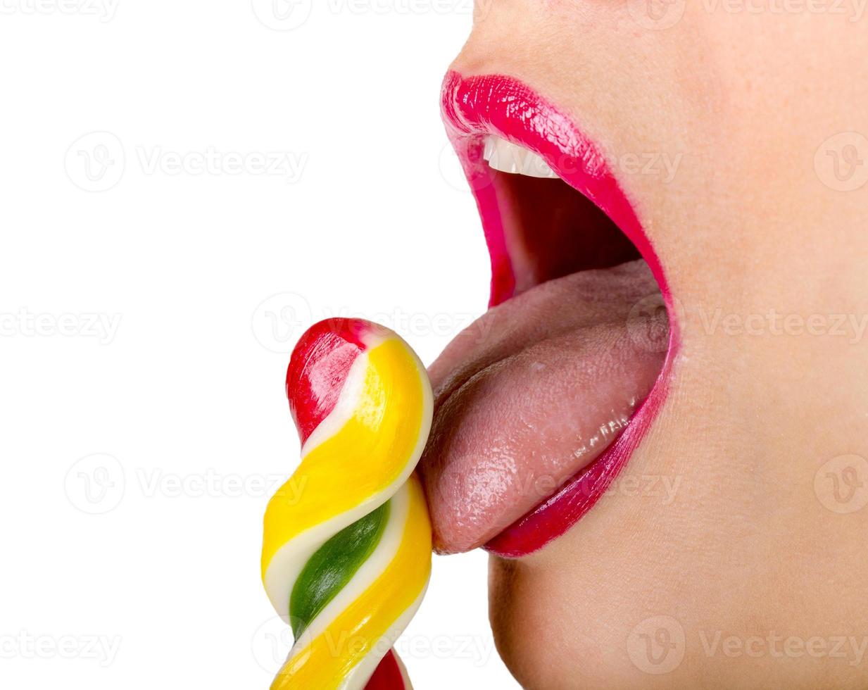 Sexy woman with red lips holding lollipop photo