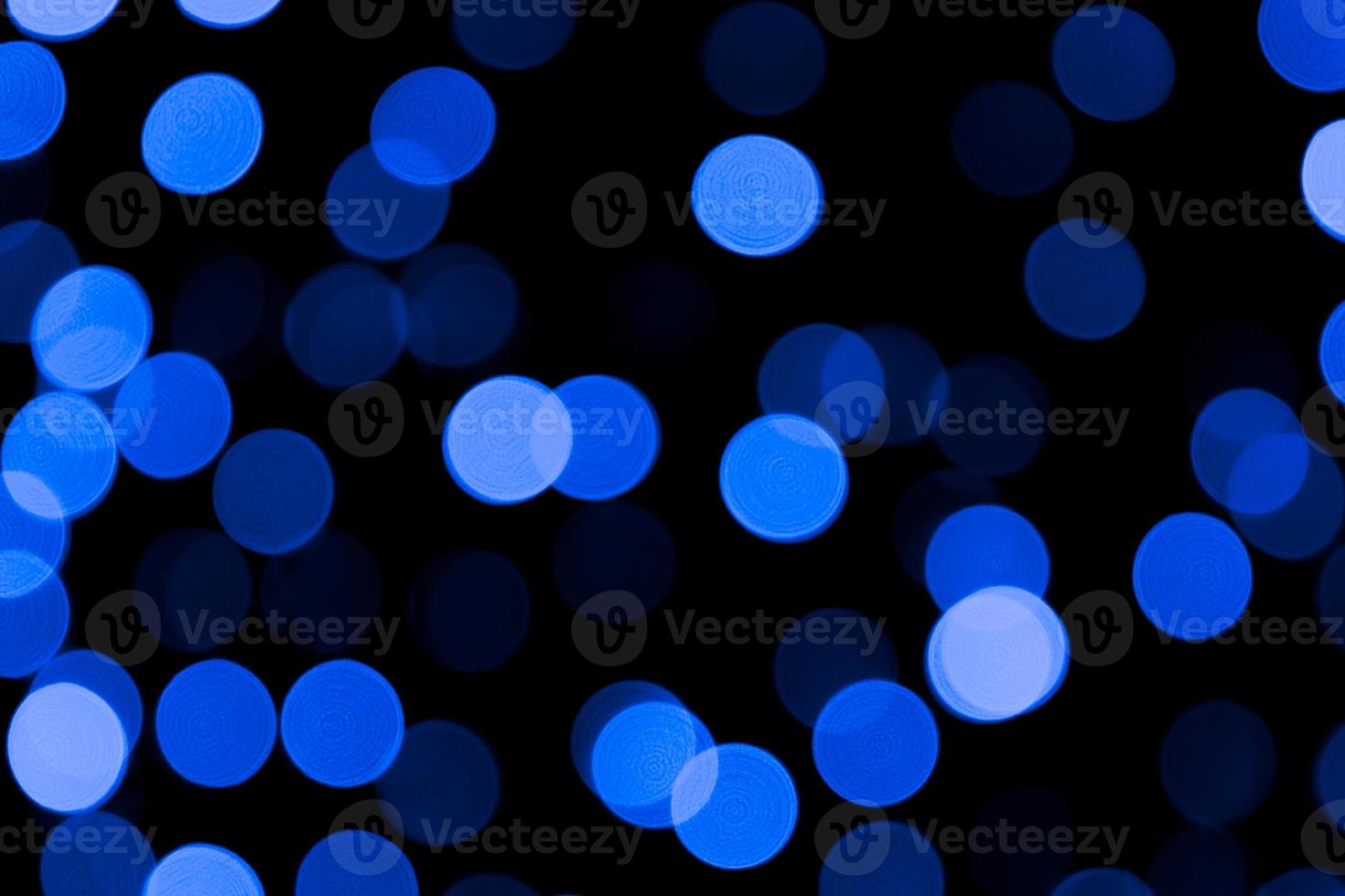 Unfocused abstract colourful bokeh black background. defocused and blurred many round blue light photo