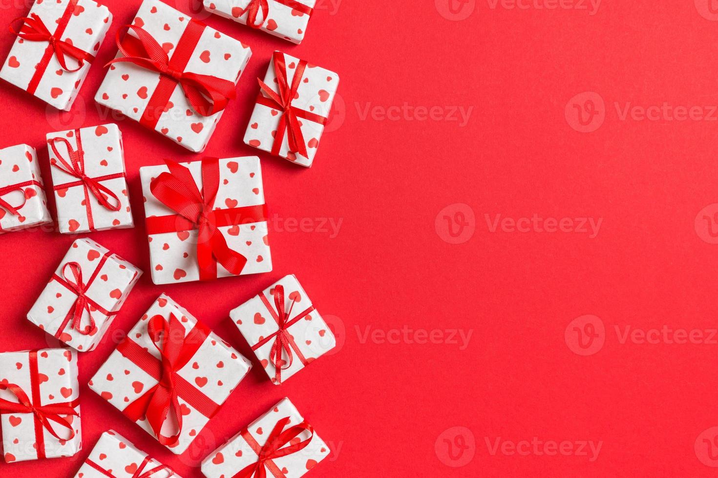 Top view colorful valentine background made of gift boxes with red hearts. Valentine's Day concept with copy space photo