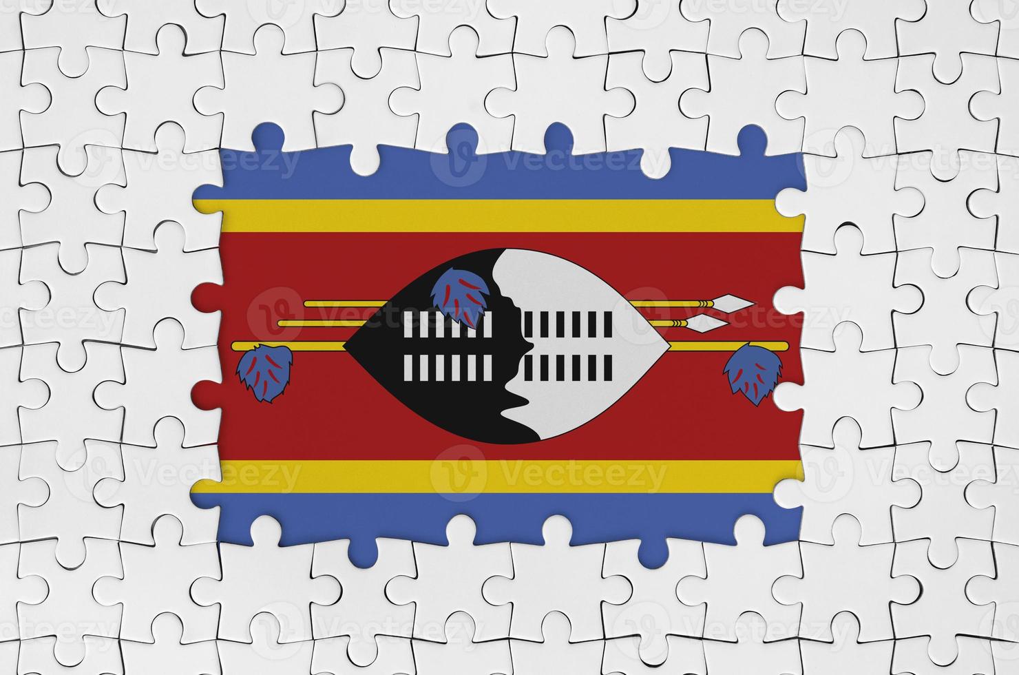 Swaziland flag in frame of white puzzle pieces with missing central part photo