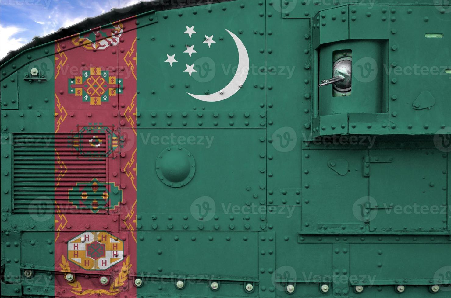 Turkmenistan flag depicted on side part of military armored tank closeup. Army forces conceptual background photo