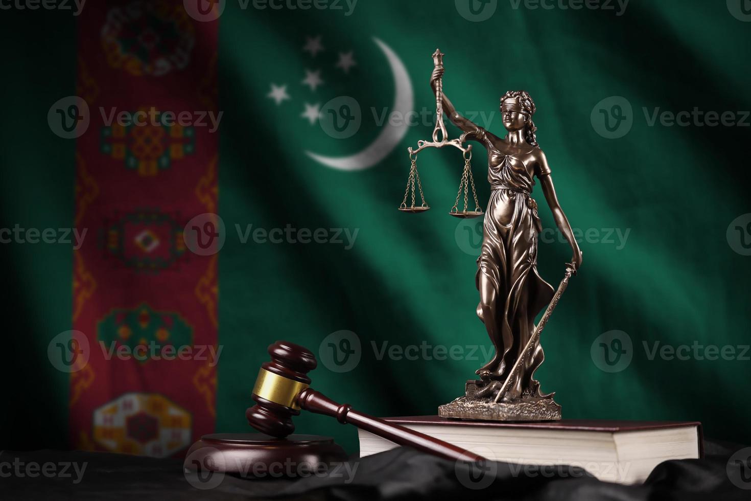 Turkmenistan flag with statue of lady justice, constitution and judge hammer on black drapery. Concept of judgement and guilt photo