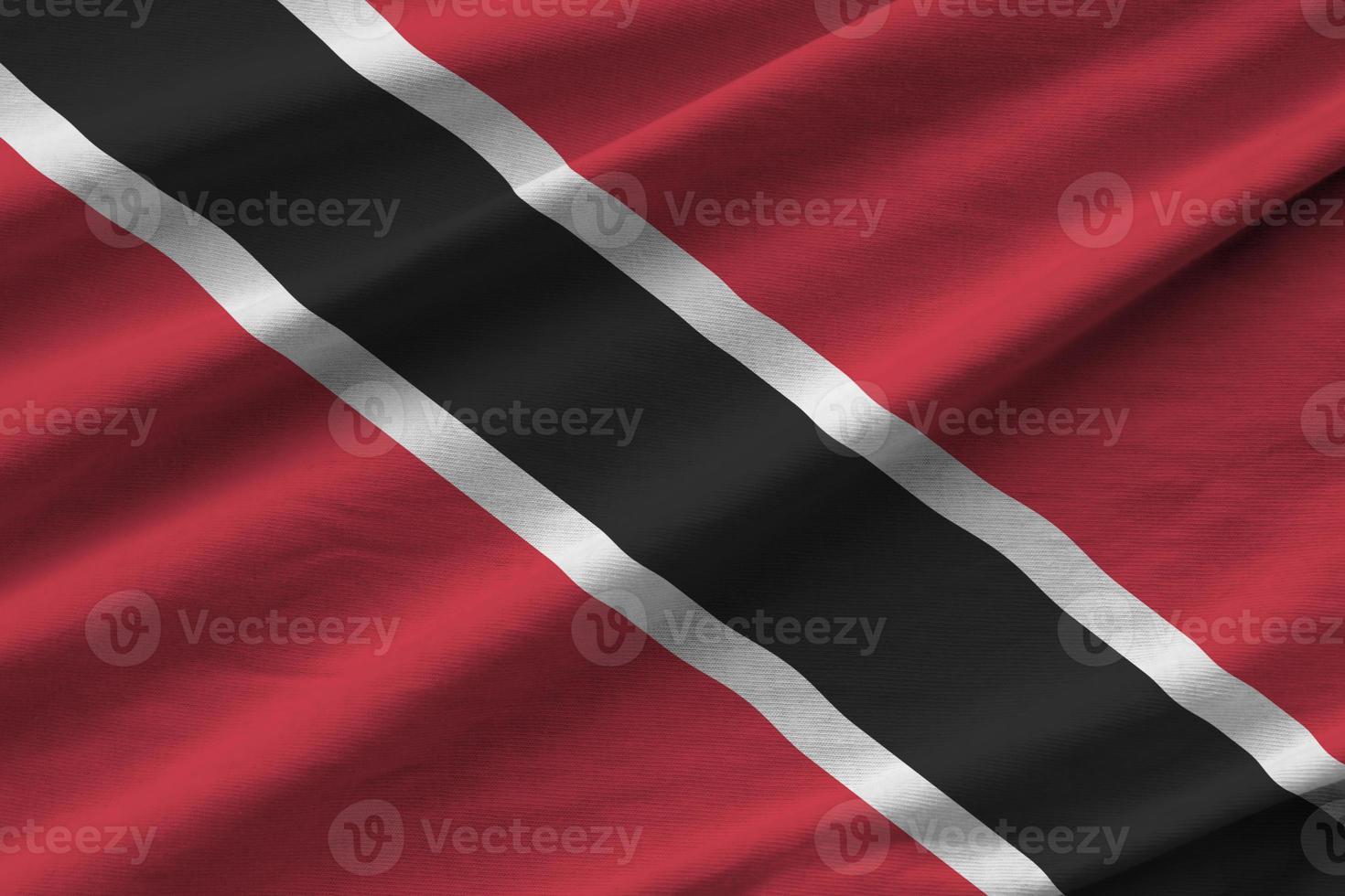 Trinidad and Tobago flag with big folds waving close up under the studio light indoors. The official symbols and colors in banner photo