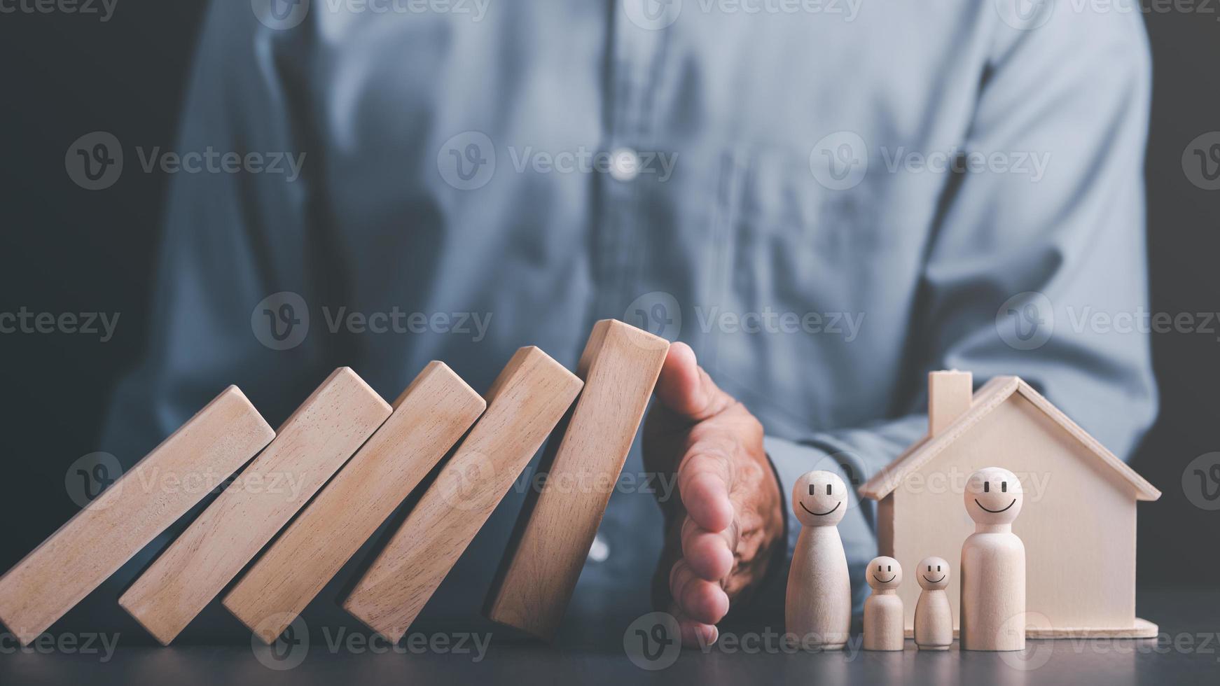 Human hand blocking wooden blocks,Represents protection and protection of safety,concept of insurance management planning To ensure both health and financial safety,Property and Family Risk Reduction photo