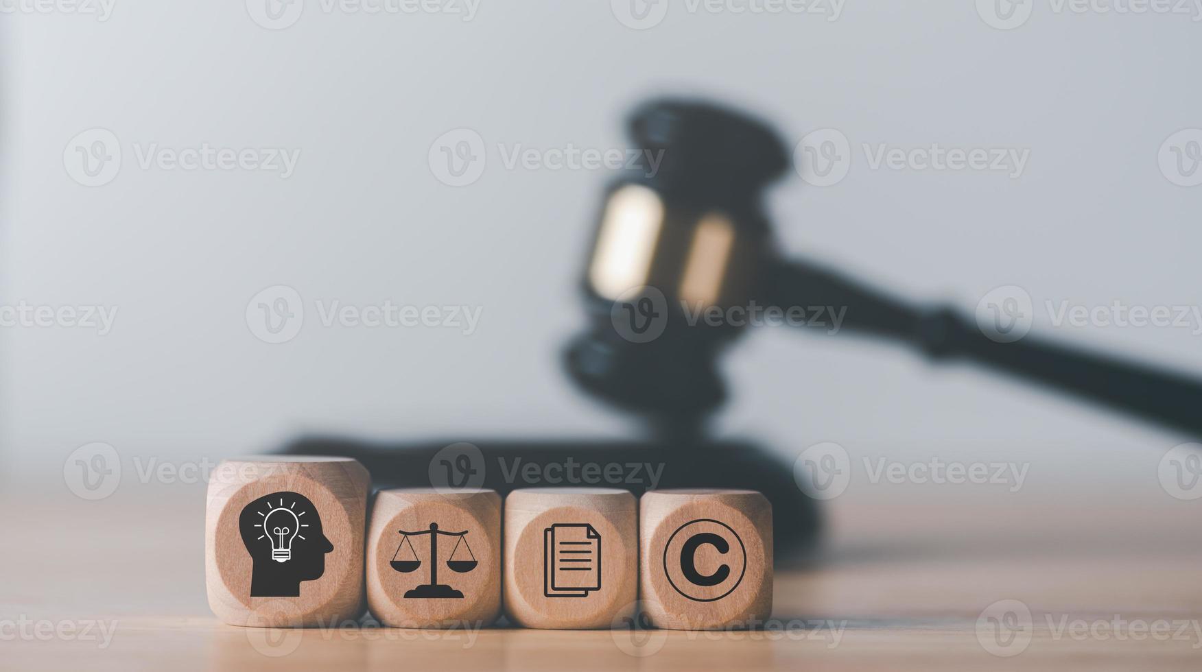 wooden blocks and Wooden judge gavel on the table, concept of copyright or intellectual property patent protection of copyright infringement proprietary declaration Legitimate innovations photo