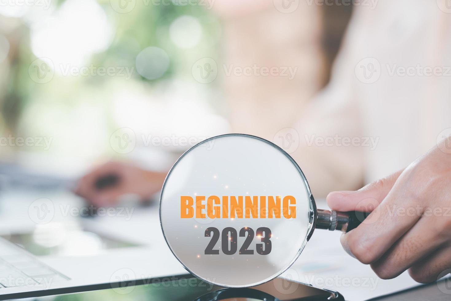 New Year 2023 Beginning Concept,man holding a magnifying glass,Finding new goals to develop and expand the business,future changes for success,direction and action for strategic planning photo