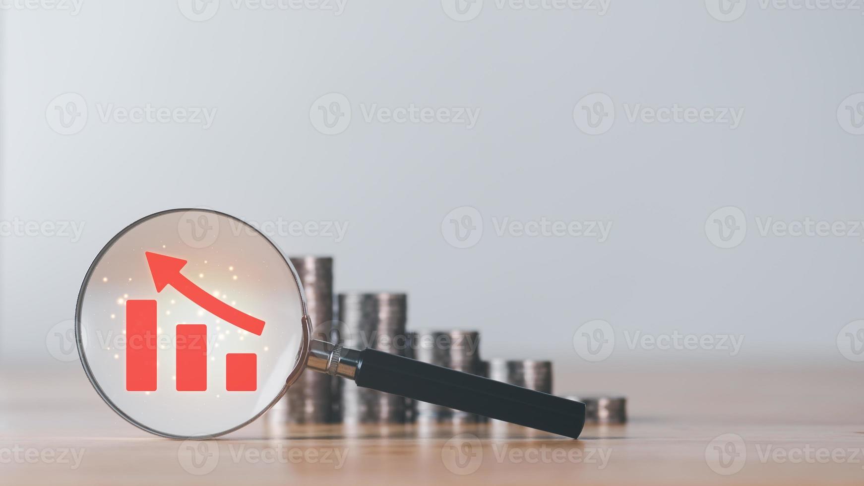 Stacks of coins, magnifying glass, and graph showing profit increase,business growth,concept of progress in development financial performance and investment,with business strategies for future goals photo