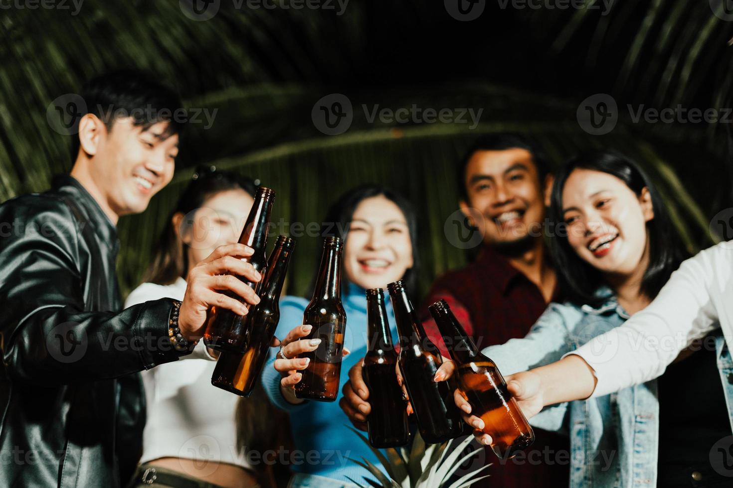Asian friends Drinking beer outdoors in the garden photo