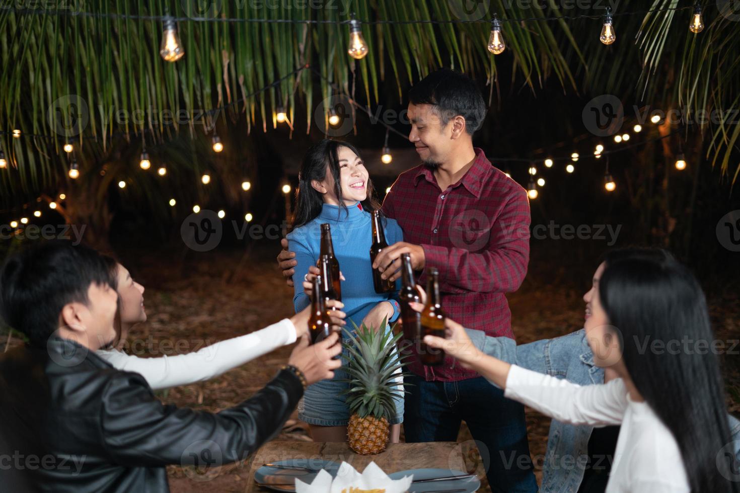 Young couple and friends celebrate a happy holiday party together. photo