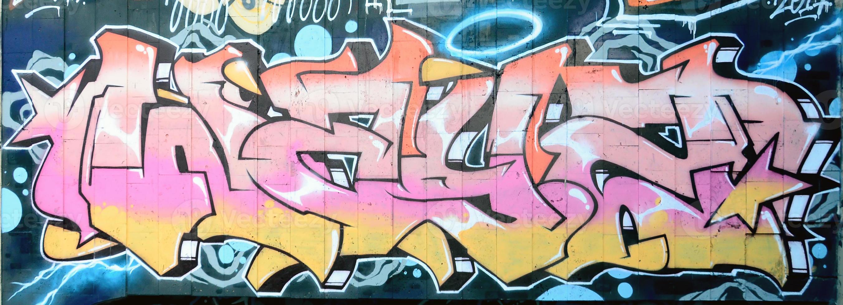 A fragment of detailed graffiti of a drawing made with aerosol paints on a wall of concrete tiles. Background image of street art in beige and pink color tones photo