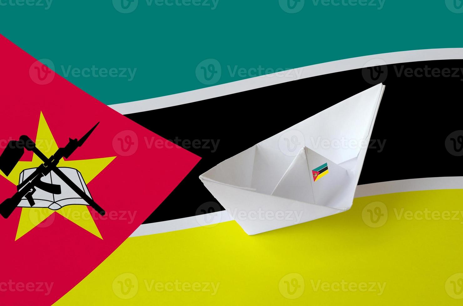 Mozambique flag depicted on paper origami ship closeup. Handmade arts concept photo