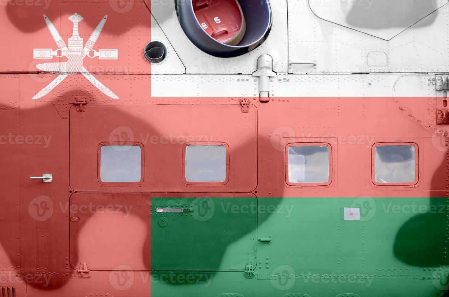 Oman flag depicted on side part of military armored helicopter closeup. Army forces aircraft conceptual background photo