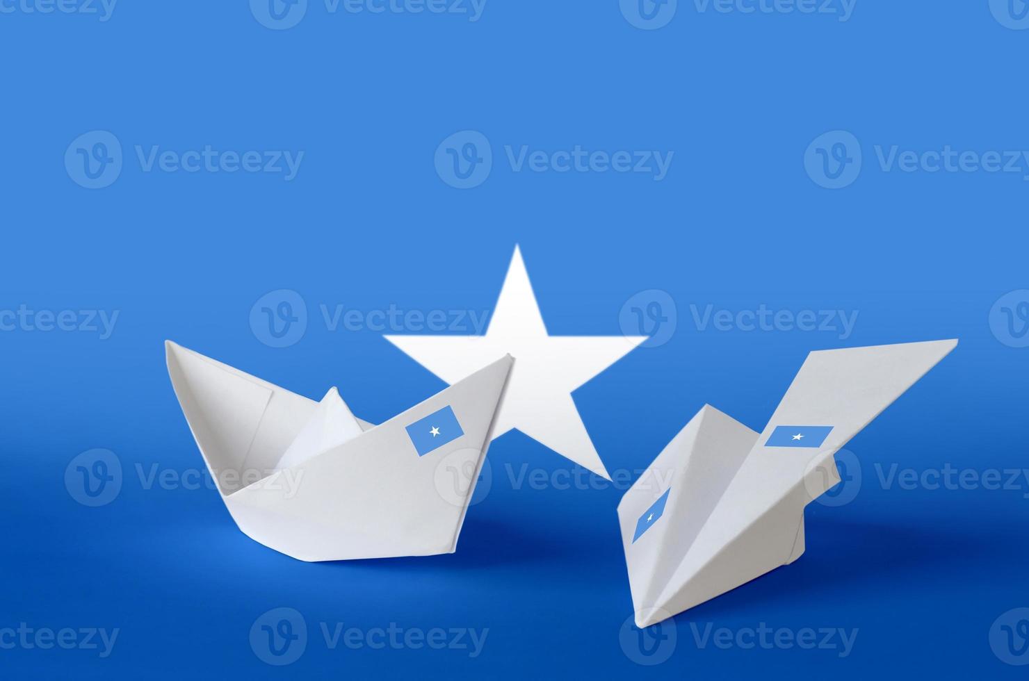 Somalia flag depicted on paper origami airplane and boat. Handmade arts concept photo