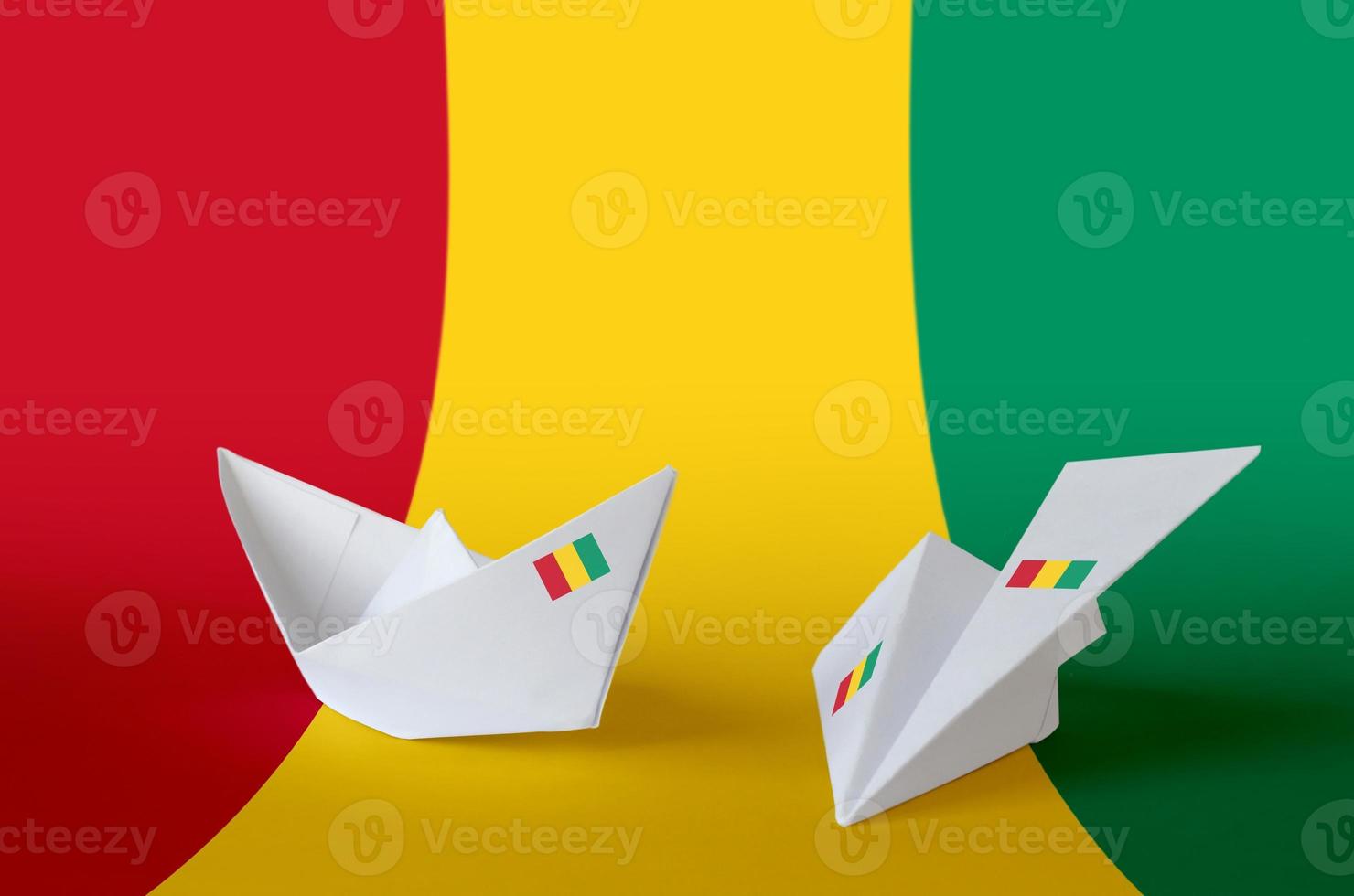 Guinea flag depicted on paper origami airplane and boat. Handmade arts concept photo