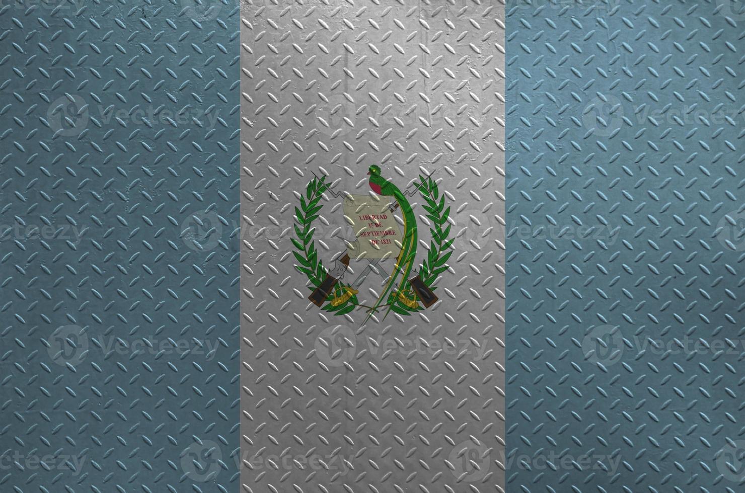Guatemala flag depicted in paint colors on old brushed metal plate or wall closeup. Textured banner on rough background photo