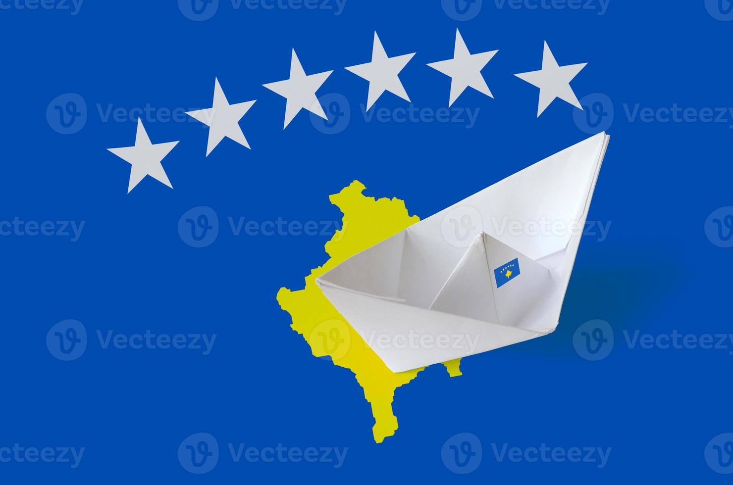 Kosovo flag depicted on paper origami ship closeup. Handmade arts concept photo