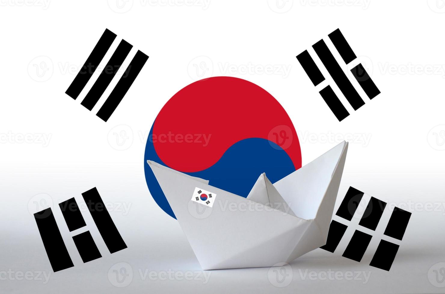 South Korea flag depicted on paper origami ship closeup. Handmade arts concept photo