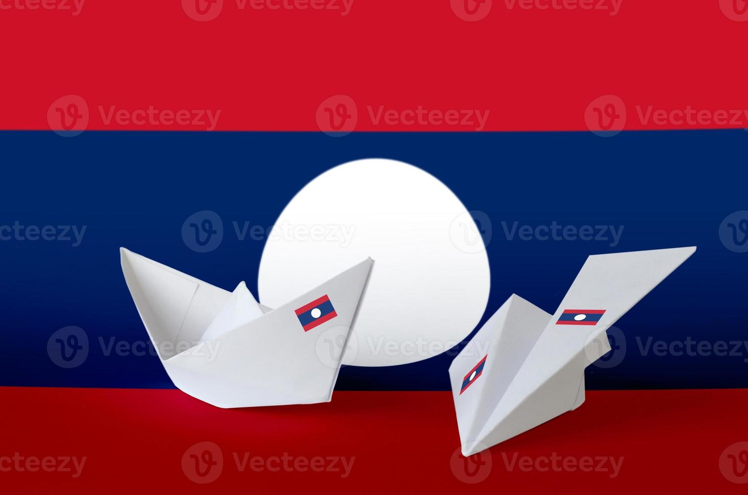 Laos flag depicted on paper origami airplane and boat. Handmade arts concept photo